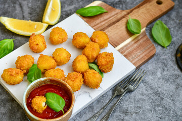 Crispy  deep fried   chicken  nuggets . Breaded  with Cornflakes Breast fillets  with chilly peppers and fresh   basil on wooden rustic background