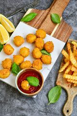 Crispy  deep fried   chicken  nuggets . Breaded  with Cornflakes Breast fillets  with chilly peppers and fresh   basil on wooden rustic background