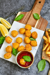 Crispy  deep fried   chicken  nuggets . Breaded  with Cornflakes Breast fillets  with chilly peppers and fresh   basil on wooden rustic background