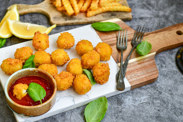 Crispy  deep fried   chicken  nuggets . Breaded  with Cornflakes Breast fillets  with chilly peppers and fresh   basil on wooden rustic background