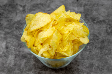 Potato chips or Crispy in a bowl on a dark background. Close up