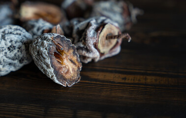Dried persimmon on a wooden background. Healthy diet