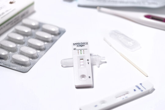 COVID-19 rapid antigen test positive result, thermometer and Paracetamol, immunochromatography of antibodies to detect infections