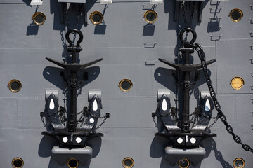 two black anchors on the side board of the Russian Aurora cruiser close up filled frame front view...