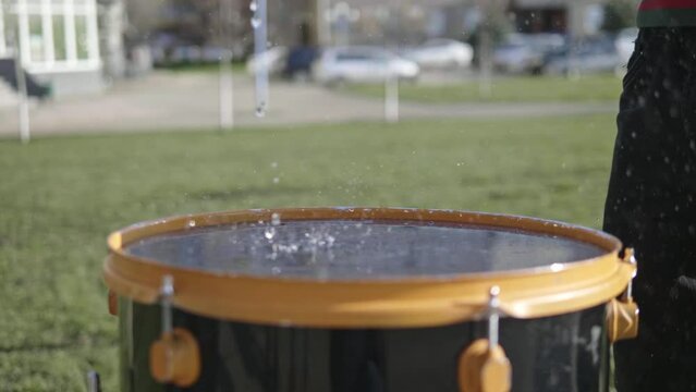 drumsticks in male hands beat the big drum on the street.