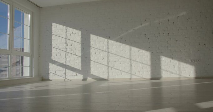 Time-lapse of sun lighting the room of an empty apartment, window shadow background, 4k