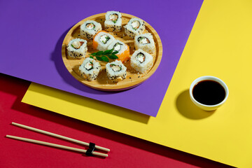 Fish food - sushi, on a bright colored background.