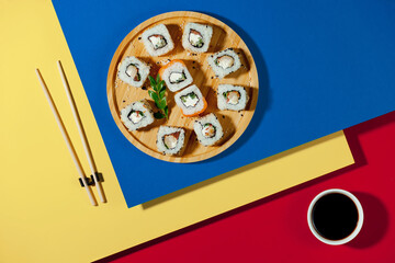 Fish food - sushi, on a bright colored background.