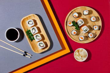 Sushi on a plate on a bright, colored background. 