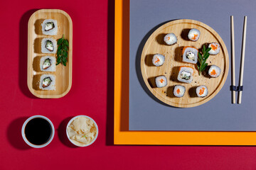 Sushi on a plate on a bright, colored background. 
