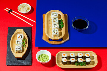 Sushi on a plate on a bright, colored background.