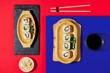 Sushi on a plate on a bright, colored background. 