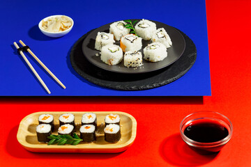 Sushi on a plate on a bright, colored background. 