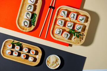 Sushi on a plate on a bright, colored background. 