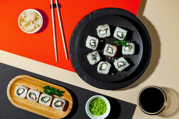 Sushi on a plate on a bright, colored background. 