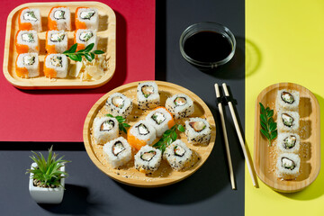 Sushi on a plate on a bright, colored background. 