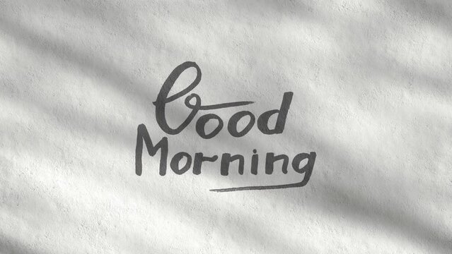 Good Morning handwriting text written on a bright white concrete wall on a sunny day, motivational quote, moving shadow of trees, modern design, seamless motion background, animation loop stock video
