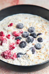 oatmeal chia seeds and berries raspberry, blueberry tasty breakfast fresh portion healthy meal food diet still life on the table copy space food background keto or paleo diet vegan or vegetarian