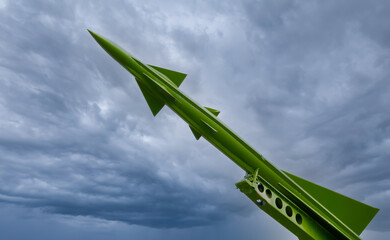 Missile on a launch pad ready to deploy in time of conflict and war. Gloomy dark clouds in the...