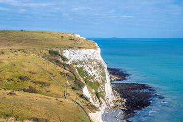 Beautiful landscape of white cliffs with sea against cloudy sky on sunny day, White cliffs of dover along sea