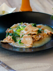 Wide Rice Noodles with pork in Gravy Sauce in black Plate or what we call 