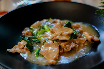 Wide Rice Noodles with pork in Gravy Sauce in black Plate or what we call 