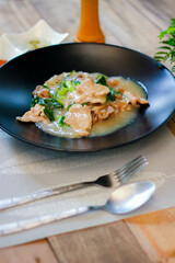 Wide Rice Noodles with pork in Gravy Sauce in black Plate or what we call 