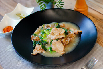 Wide Rice Noodles with pork in Gravy Sauce in black Plate or what we call 