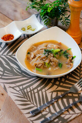 Wide Rice Noodles with pork in Gravy Sauce in white Plate or what we call 