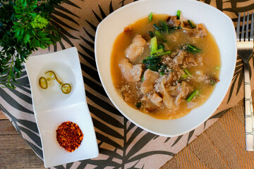 Wide Rice Noodles with pork in Gravy Sauce in white Plate or what we call 