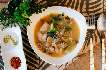 Wide Rice Noodles with pork in Gravy Sauce in white Plate or what we call 