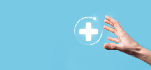 Businessman hold virtual plus medical network connection icons. Covid-19 pandemic develop people awareness and spread attention on their healthcare.