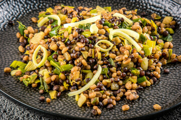 Roasted barley groats and lentils with leek, close-up