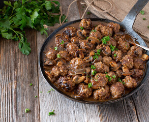Rustic pan dish with meatballs in a delicious mushroom sauce