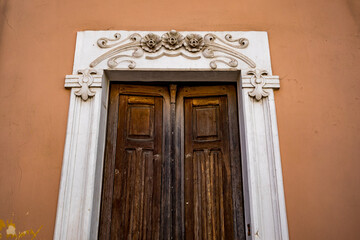 Old wooden door. Empty street architectural view, Cellino San Marco, Brindisi, Italy
