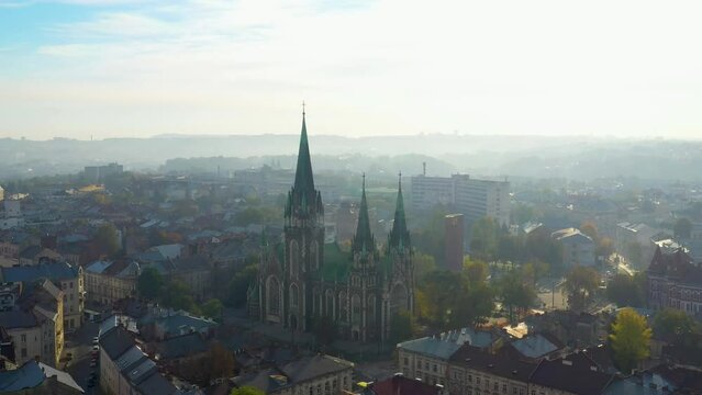 Aerial view of historical center and Church of Saints Olga and Elizabeth old gothic temple in town Lviv, Ukraine. Flying by drone over dome. 4k footage of landmarks, architecture of european Lviv city
