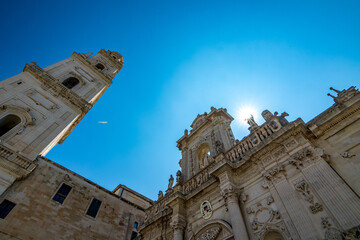 Obraz premium Sun light diffraction. Empty street low-angle architectural view, Lecce, Brindisi, Italy