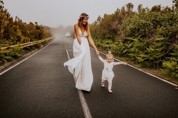 Fototapeta na wymiar mother and daughter in wedding dress in the mountains of madeira portugal