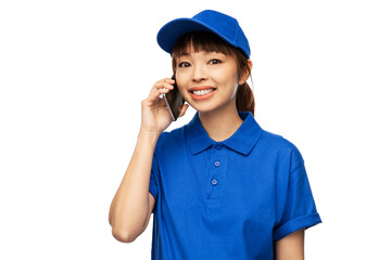 profession, job and people concept - happy smiling delivery woman in blue uniform calling on smartphone over white background