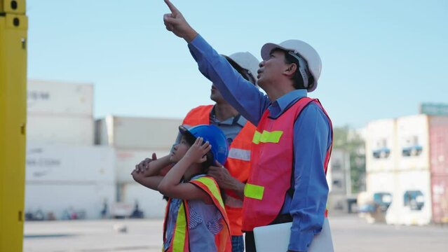 Grandfather took his son and grandchildren to see own business family at container site. Business support logistics cargo freight ship transportation, transport - importing goods internationally.