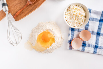 Baking homemade sweets on white table with ingredients for cooking, culinary background, copy space, overhead view