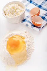 Baking homemade sweets on white table with ingredients for cooking, culinary background, copy space, overhead view