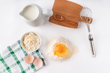 Baking homemade sweets on white table with ingredients for cooking, culinary background, copy space, overhead view