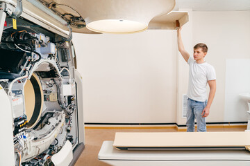 engineer removes cover of a computer tomograph. 