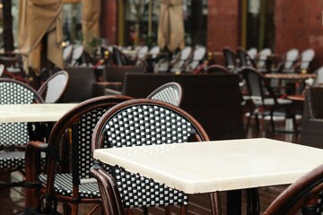 Chair and table of a restaurant on an open veranda covered with raindrop
