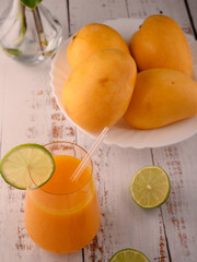 Mango juice with lime slice on vintage wooden table © ALEKSEI