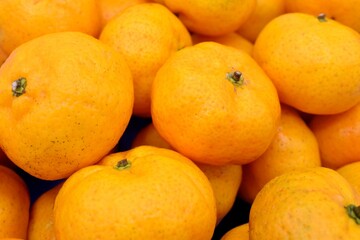 Mandarin oranges in stacks.