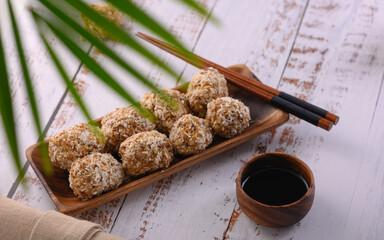 The photo shows the Japanese dessert Mochi. Round shaped sweets are composed of chickpeas, figs, almonds and honey, topped with coconut flakes