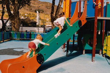 little cute girl is playing on playground in machico madeira portugal 