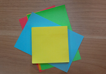 Color notepad on wooden desk. Flat lay, Directly above view